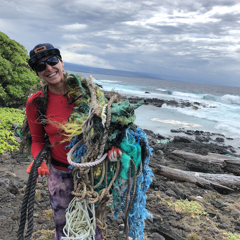 Business owner holding trash collected from the ocean